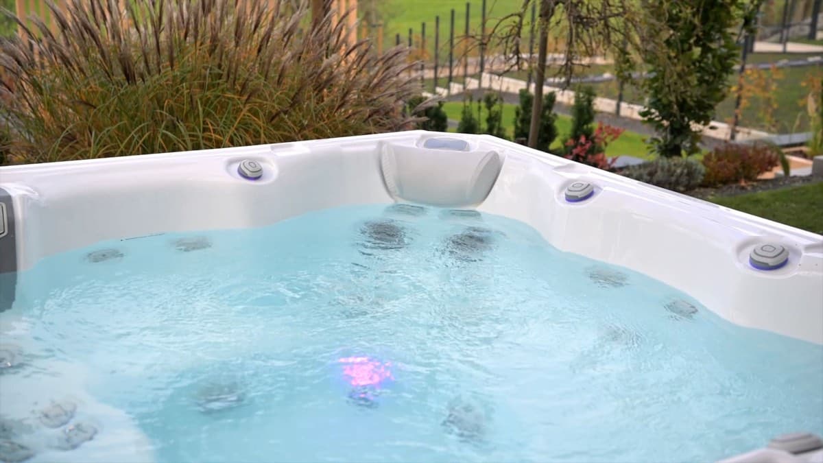 A hot tub with the jets running in a landscaped garden